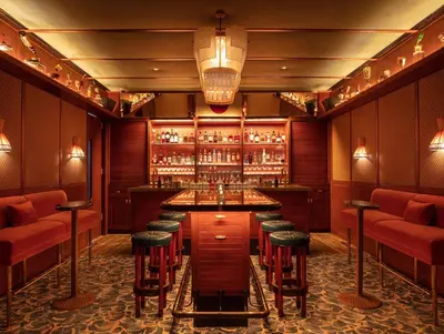 a bar with red stools and a bar counter at The Standard Spa, Miami Beach in Miami Beach