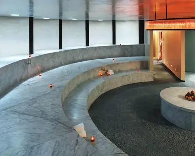 a lobby with a stone bench with a fire place at The Standard Spa, Miami Beach in Miami Beach