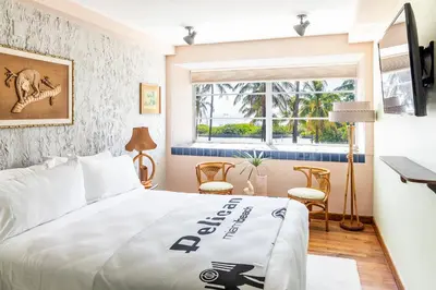a hotel room with a bed and a window at Pelican Hotel in Miami Beach