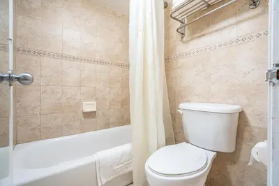 a bathroom with a toilet and a tub and a shower at Hotolos Hollywood in Hollywood