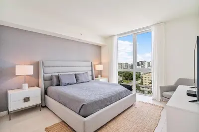 a bedroom with a bed and a large window at 914 Tiffany House condo in Fort Lauderdale