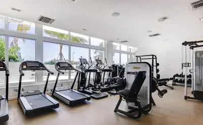 a gym with a lot of treadmills and exercise bikes at 914 Tiffany House condo in Fort Lauderdale