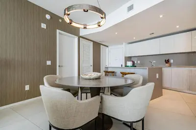 a kitchen and dining room with a table and chairs at Amazing views on the 29th floor 2BR Beach Resort in Hallandale Beach