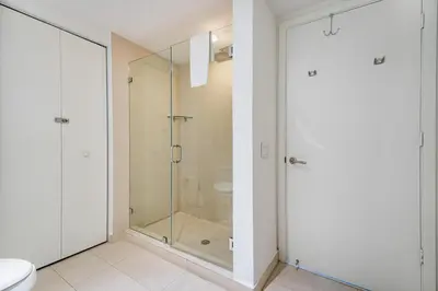 a bathroom with a glass shower and a toilet at Amazing views on the 29th floor 2BR Beach Resort in Hallandale Beach