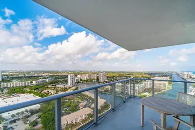 a balcony with a chair and a view of the ocean at Relaxing Getaway with Intracoastal Views in Hollywood