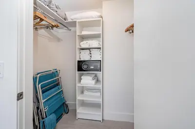 a closet with white shelves and a blue cart at Relaxing Getaway with Intracoastal Views in Hollywood