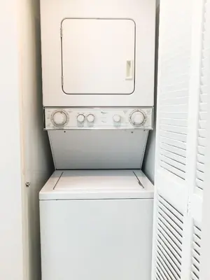 a white washer and dryer with a mirror above it at Star Stay Miami Yellow Brickell in Miami