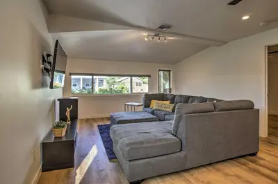 a living room with a couch and a tv at Modern Home with Shared Pool in Fort Lauderdale! in Fort Lauderdale