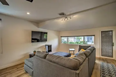 a living room with a couch and a flat screen tv at Modern Home with Shared Pool in Fort Lauderdale! in Fort Lauderdale