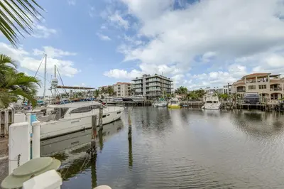 a boat docked at a marina in a city at Ft Lauderdale Apt with Pool - 1 Mi to Beach Access! in Fort Lauderdale