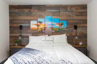 a bedroom with a white bed and a wooden wall at Casa Madeira @ the heart of Miami Design District in Miami