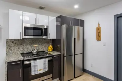a kitchen with a stainless steel refrigerator and a microwave at Casa Madeira @ the heart of Miami Design District in Miami