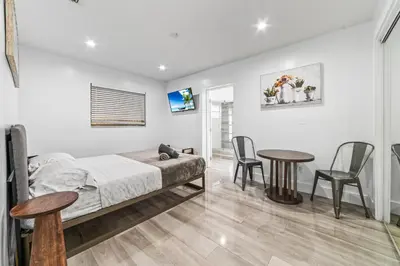 a bedroom with a bed and a table and chairs at Lakeside Vacation Home in Davie