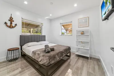 a bedroom with a bed and a tv in it at Lakeside Vacation Home in Davie