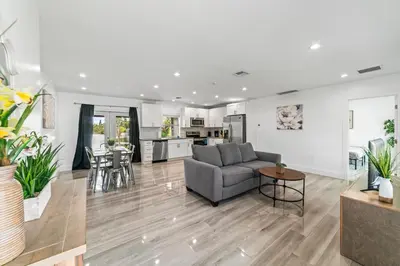 a living room with a couch and a table at Lakeside Vacation Home in Davie
