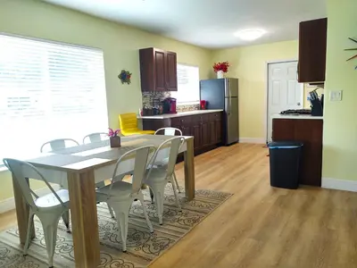 a kitchen and dining room with a table and chairs at Family, Couples Retreat near Airport, Cruise Port & Beaches in Fort Lauderdale