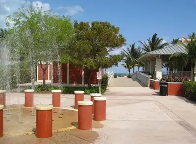a row of orange posts on a sidewalk next to a building at Gorgeous Beachy Chic Condo in Key Biscayne in Miami