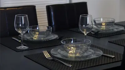 a table with four empty wine glasses and silverware at THE TIDES on MIAMI HOLLYWOOD in Hollywood