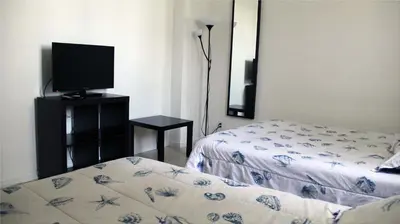 a bedroom with a bed and a flat screen tv at THE TIDES on MIAMI HOLLYWOOD in Hollywood