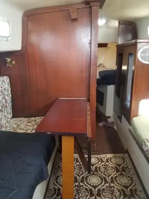 a wooden table in a room with a bed at Unique perspective in Miami