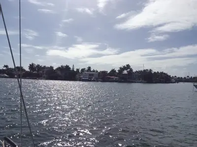 a boat in a body of water with houses at Unique perspective in Miami