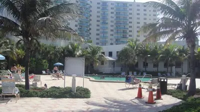 a resort with a swimming pool and palm trees at Miami HOLLYWOOD in Hollywood