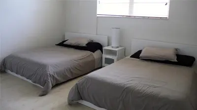 a bedroom with two beds and a window at Miami HOLLYWOOD in Hollywood
