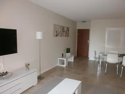 a living room with a tv and a table with chairs at Miami HOLLYWOOD in Hollywood