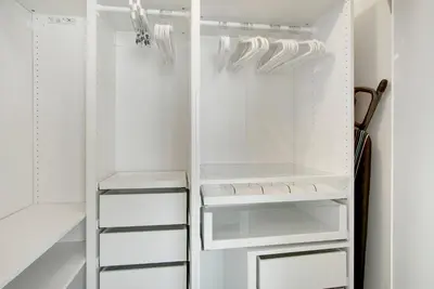 a white walk in closet with white cabinets at NEW!!! W Brickell Miami- ICON DELUXE LOUNGE with 2 masters in Miami