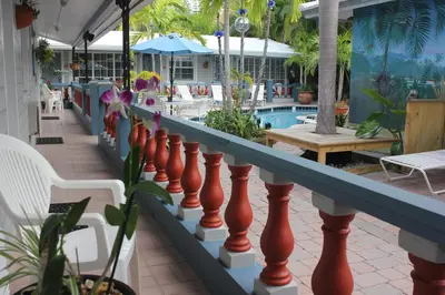 a balcony with a fence and a swimming pool at Coral Reef Guesthouse in Fort Lauderdale