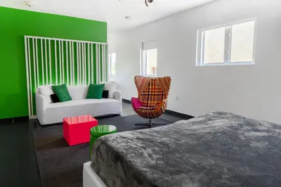 a bedroom with a bed and a couch and a chair at Blanc Kara- Adults Only in Miami Beach