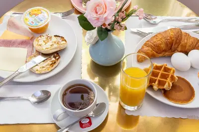 a table topped with plates of breakfast foods and a cup of coffee at Blanc Kara- Adults Only in Miami Beach