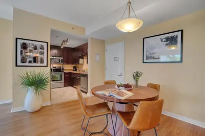 a kitchen and dining room with a table and chairs at Dharma Home Suites South Miami at Red Road Commons in Miami