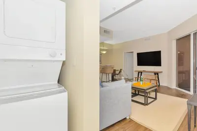 a kitchen and a living room with a tv at Dharma Home Suites South Miami at Red Road Commons in Miami