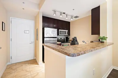 a kitchen with a counter and a stove top oven at Dharma Home Suites South Miami at Red Road Commons in Miami