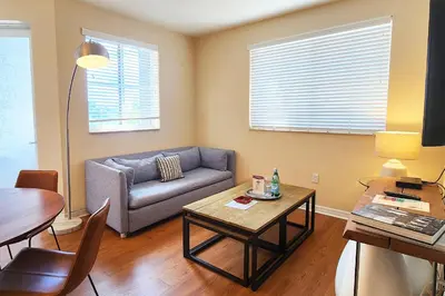 a living room with a couch and a table at Dharma Home Suites South Miami at Red Road Commons in Miami