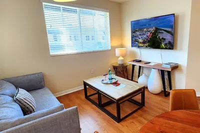 a living room with a couch and a table at Dharma Home Suites South Miami at Red Road Commons in Miami