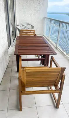a wooden table and chairs on a balcony at Star Stay Miami Orange Brickell in Miami
