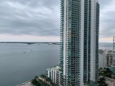 a tall building next to a large body of water at Star Stay Miami Orange Brickell in Miami