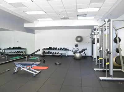 a gym with several treadmills and exercise machines at Star Stay Miami Orange Brickell in Miami