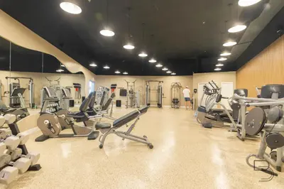 a gym with lots of cardio equipment in a room at Girasole Apartments in Miami Beach