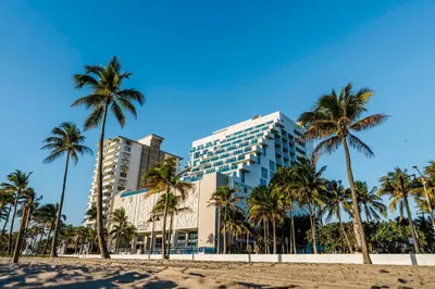 a hotel on the beach with palm trees at Hotel Maren Fort Lauderdale Beach, Curio Collection By Hilton in Fort Lauderdale