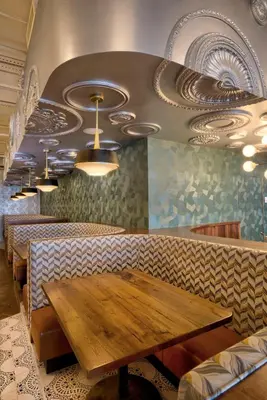 a dining room with a wooden table in a restaurant at Hotel Maren Fort Lauderdale Beach, Curio Collection By Hilton in Fort Lauderdale