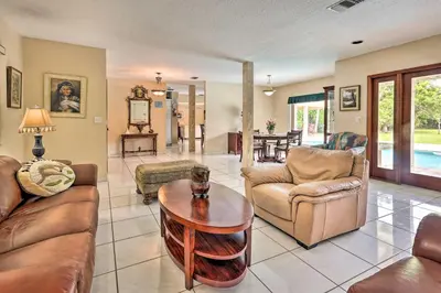 a living room with leather furniture and a table at Home with Pool in Upscale Pinecrest Village in Miami