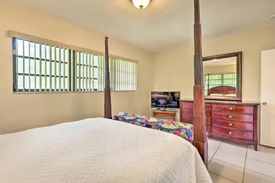 a bedroom with a bed and a dresser and a mirror at Home with Pool in Upscale Pinecrest Village in Miami