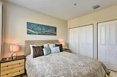a bedroom with a bed and two night stands with lamps at Miami Apartment by Coral Gables - Great Location! in Miami