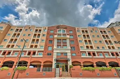 a large brick building in front of a building at Miami Apartment by Coral Gables - Great Location! in Miami