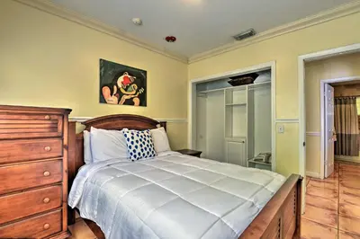 a bedroom with a bed and a wooden dresser at Quaint Central Miami Bungalow 10 Mi to Mid-Beach! in Miami