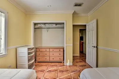 a bedroom with a closet with a bed and a dresser at Quaint Central Miami Bungalow 10 Mi to Mid-Beach! in Miami