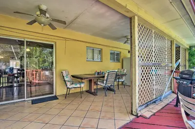 a screened in porch with a table and chairs at Quaint Central Miami Bungalow 10 Mi to Mid-Beach! in Miami